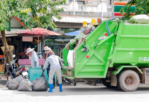 Business professionals managing waste removal in an office setting in Leyton