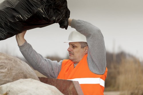 Professional waste removal team handling large containers in Leyton